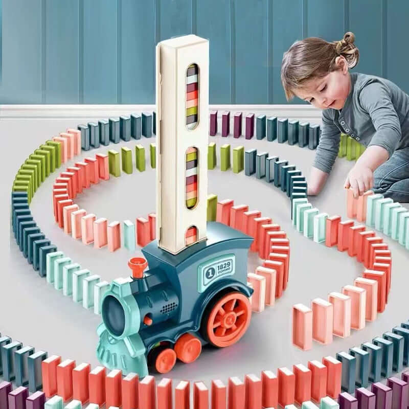 Child playing with automatic domino train toy, laying out colorful dominoes in a fun, creative design.
