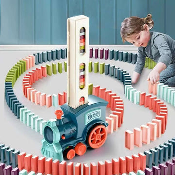 Child playing with automatic domino train toy, laying out colorful dominoes in a fun, creative design.